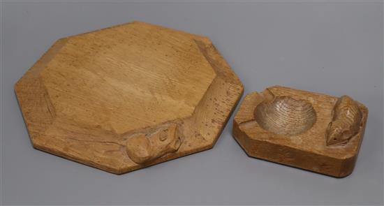 A Robert Mouseman Thompson octagonal oak cheese board/pot stand and an ashtray, each with carved mouse signature